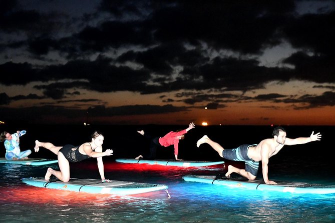 Night SUP Yoga in Honolulu, Hawaii - Getting comfortable on the SUP board