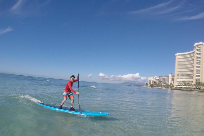 Semi-Private Stand Up Paddle Lesson with Waikiki Courtesy Shuttle - Getting fitted with a board, paddle, and reef shoes